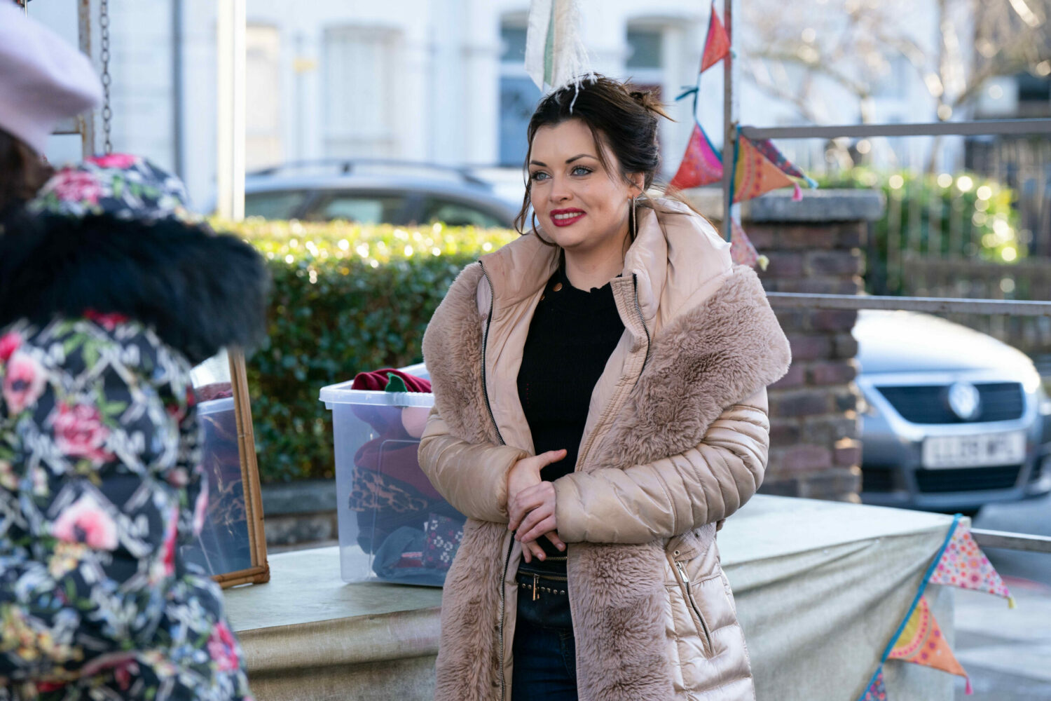 Whitney smiling at the market on EastEnders