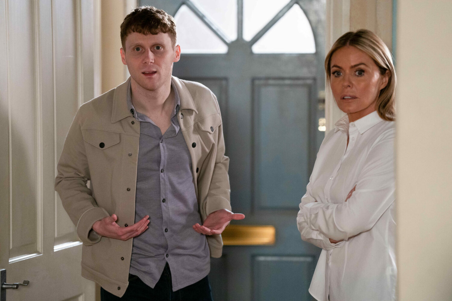 Jay looks outraged while Emma stands, arms crossed, on EastEnders