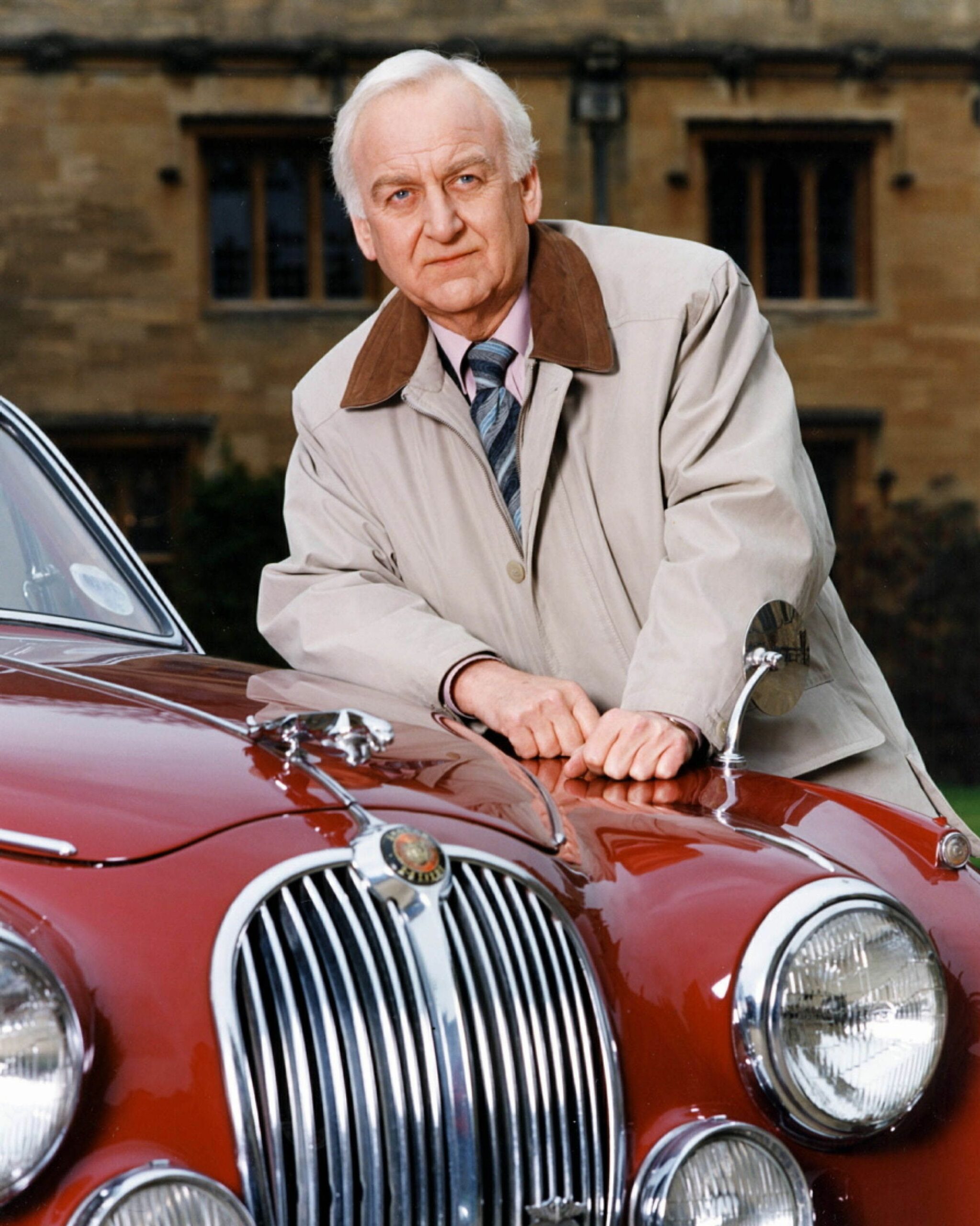John Thaw leans on his Jaguar in Inspector Morse