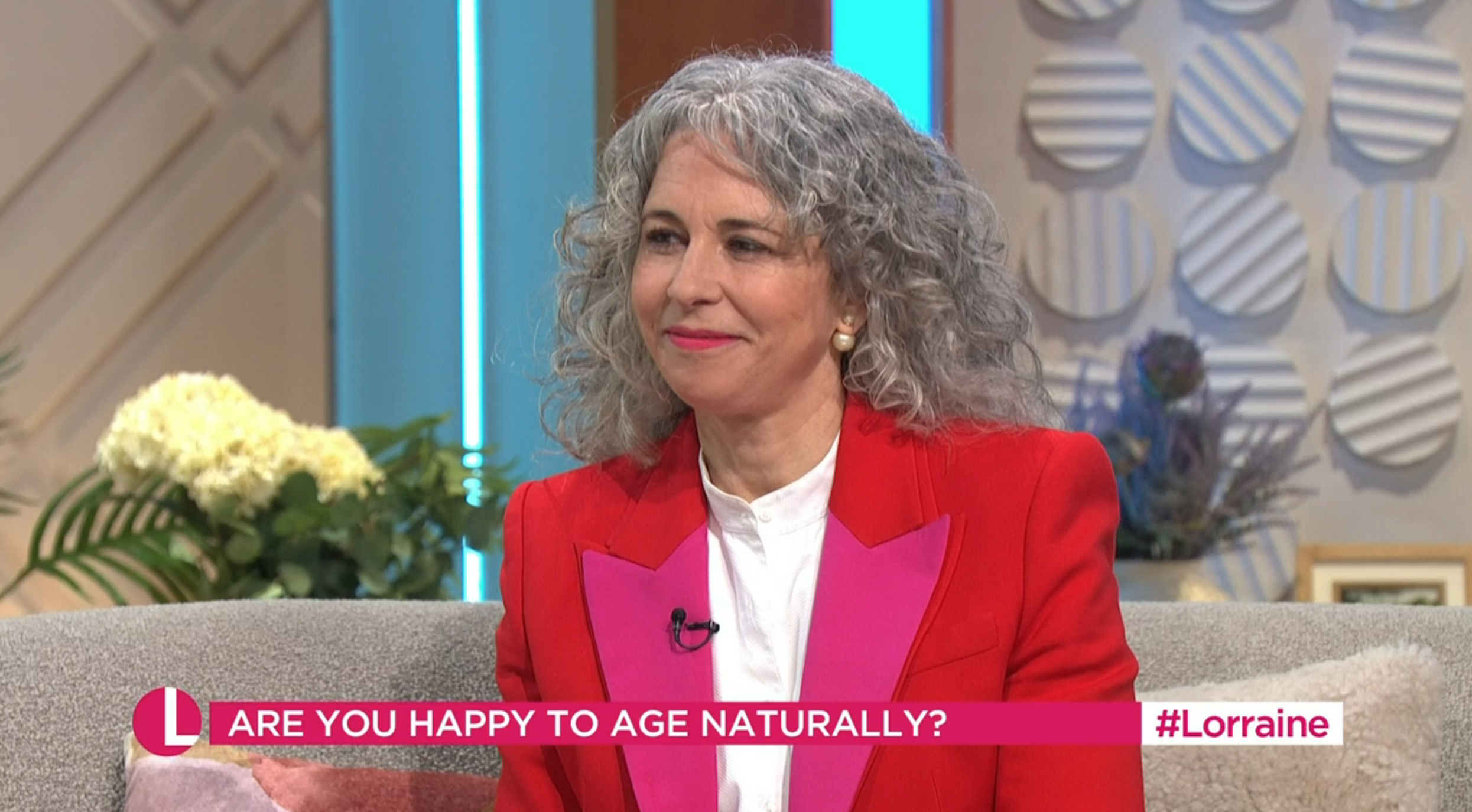 Woman in red being interviewed on Lorraine today