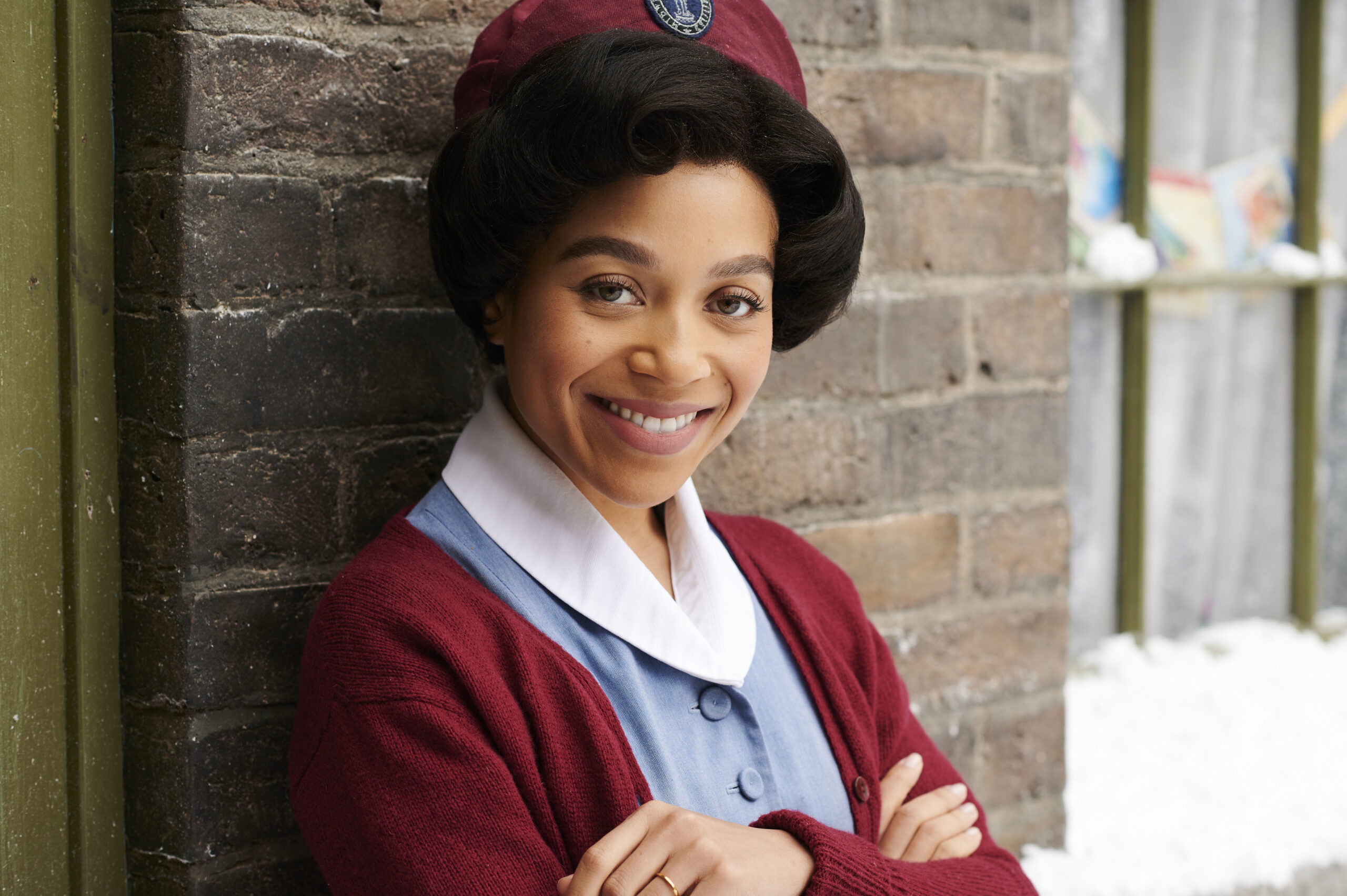 Nurse Lucille smiles outside in Call the Midwife