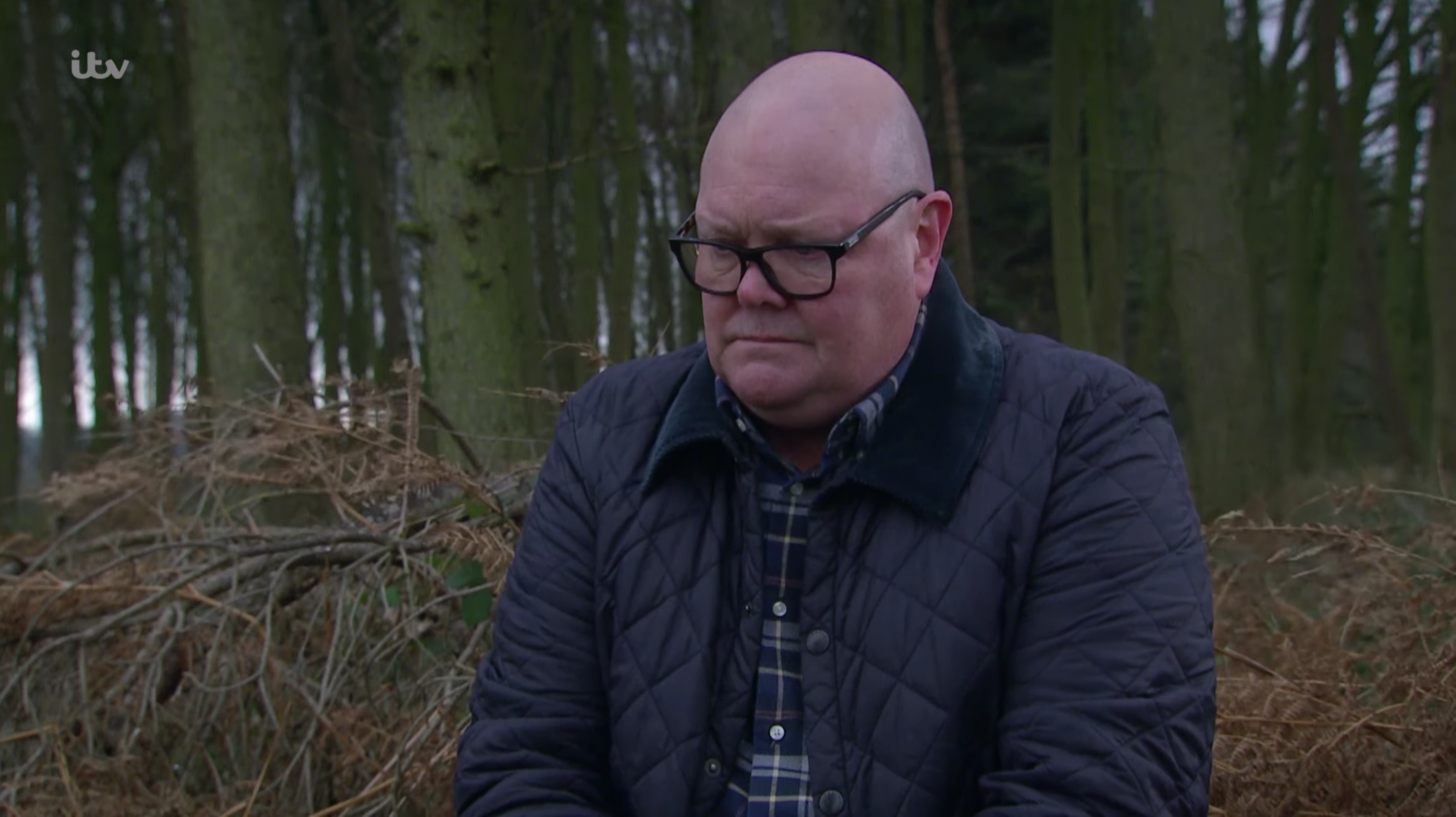 Paddy looking depressed in the woods on Emmerdale