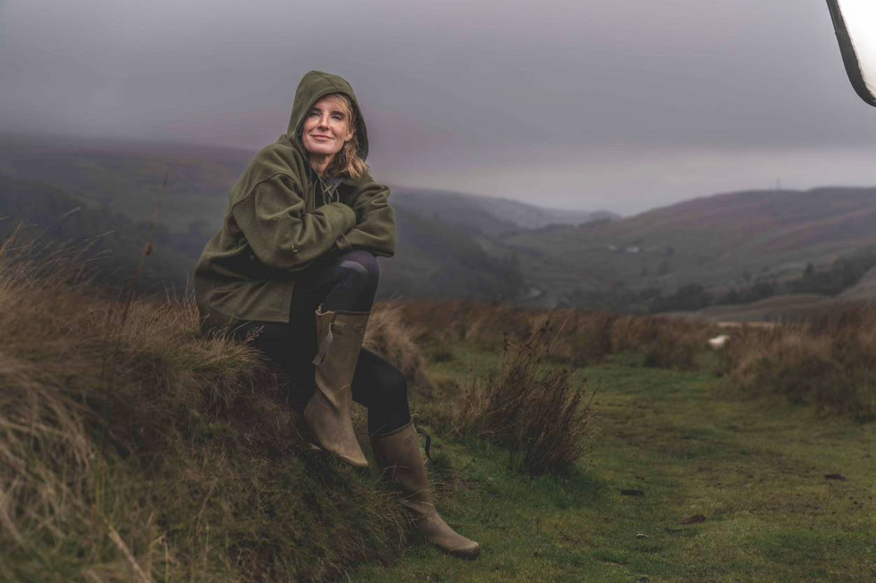 Yorkshire Shepherdess Amanda Owen sitting on a rock