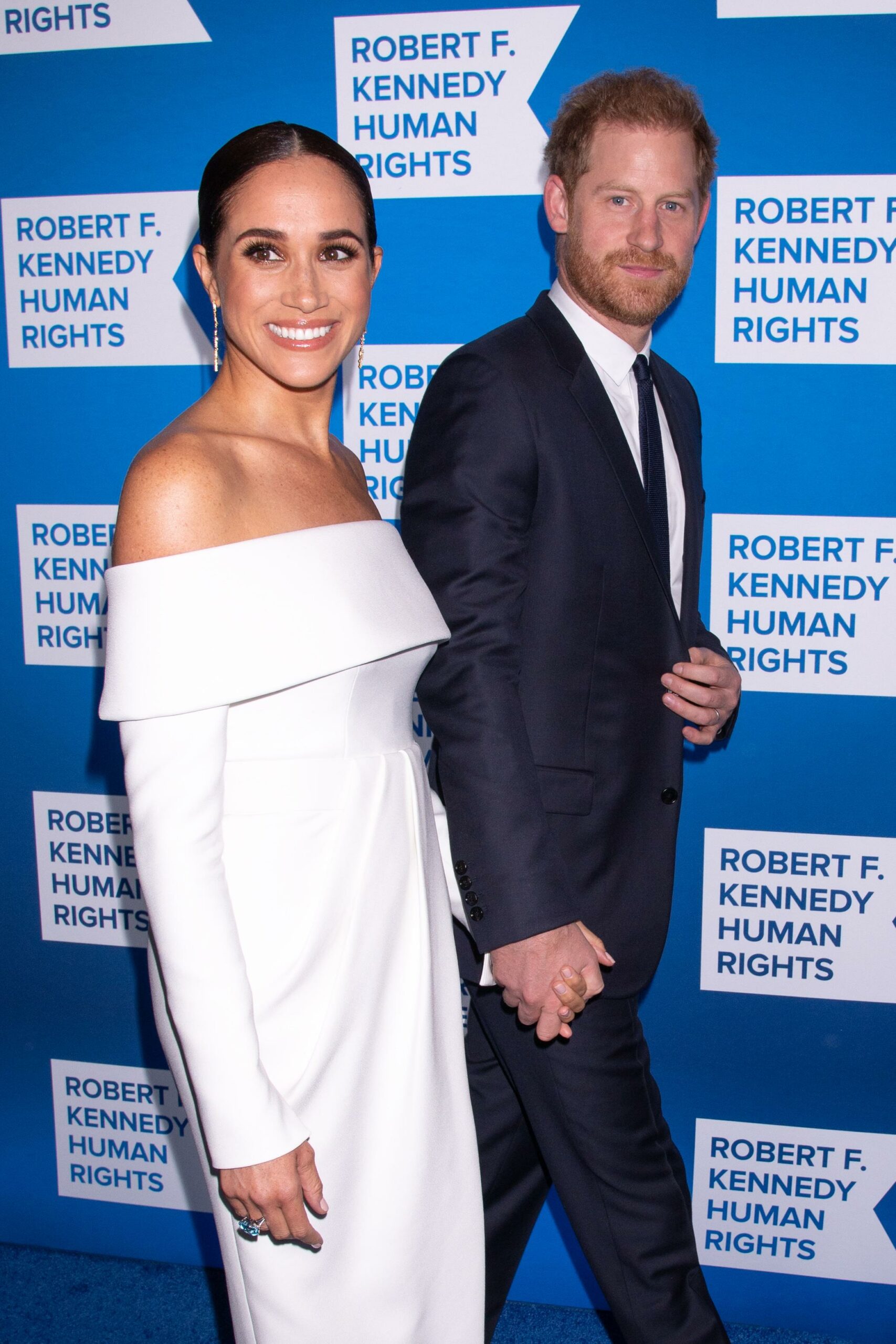 Prince Harry and Meghan standing together on the red carpet