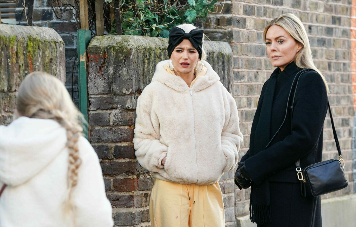 Lola and Emma look worriedly at Lexi in the Square