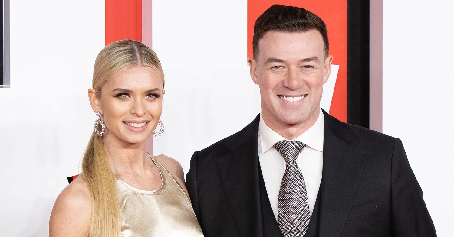 Nadiya Bychkova and Kai Widdrington smiling on a red carpet