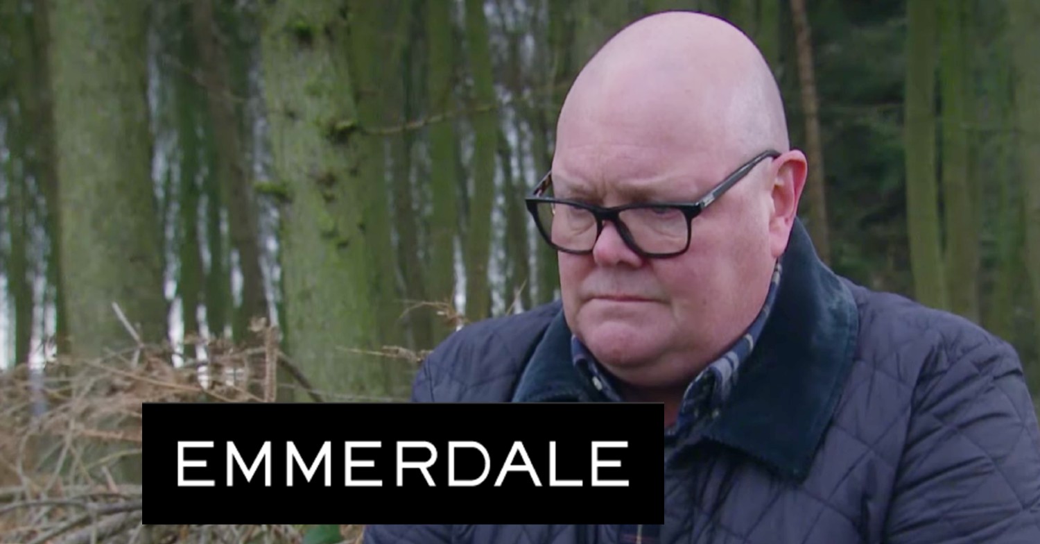 Screenshot of Paddy looking depressed on Emmerdale with the logo