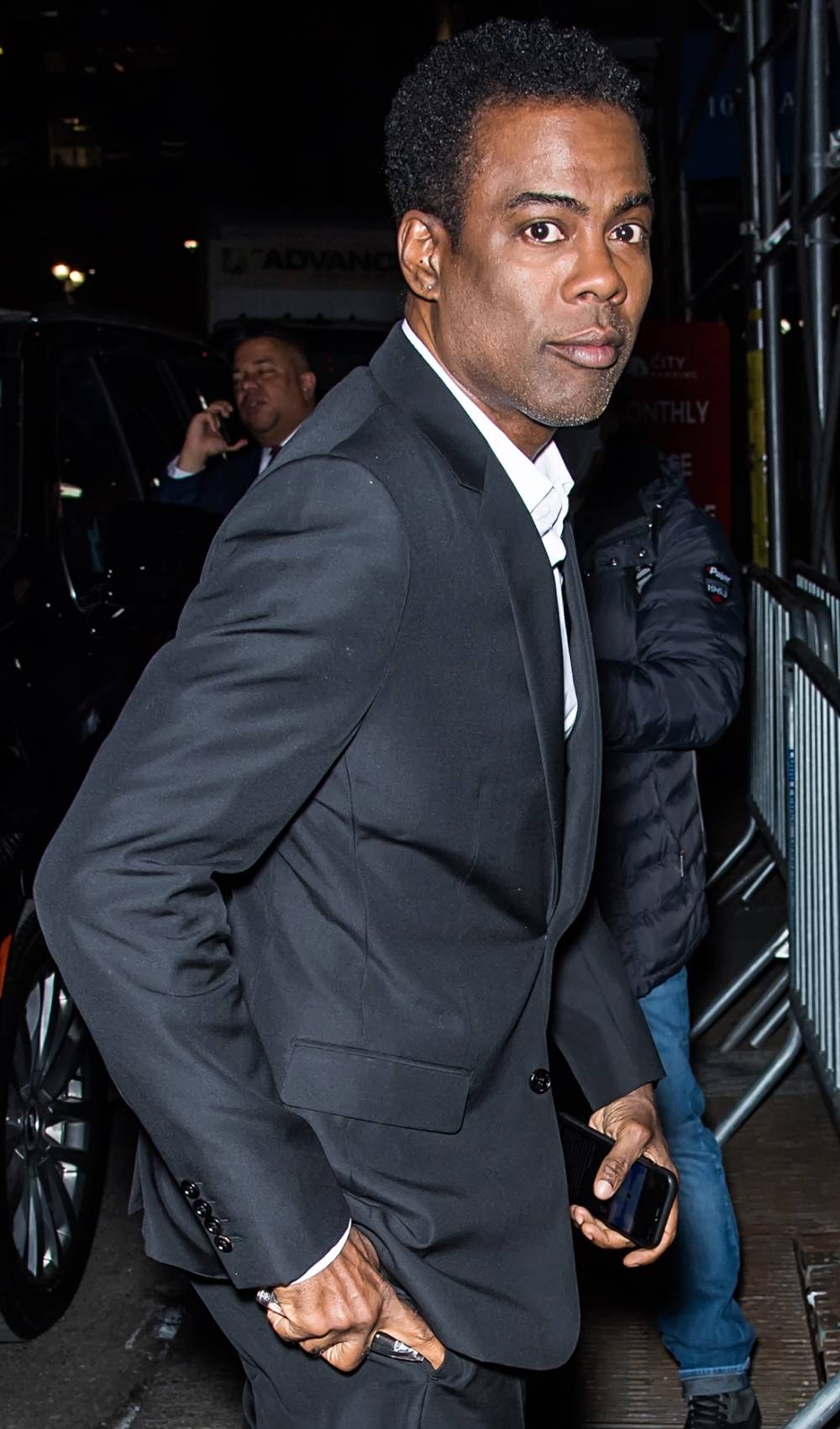 Chris Rock looks to his right