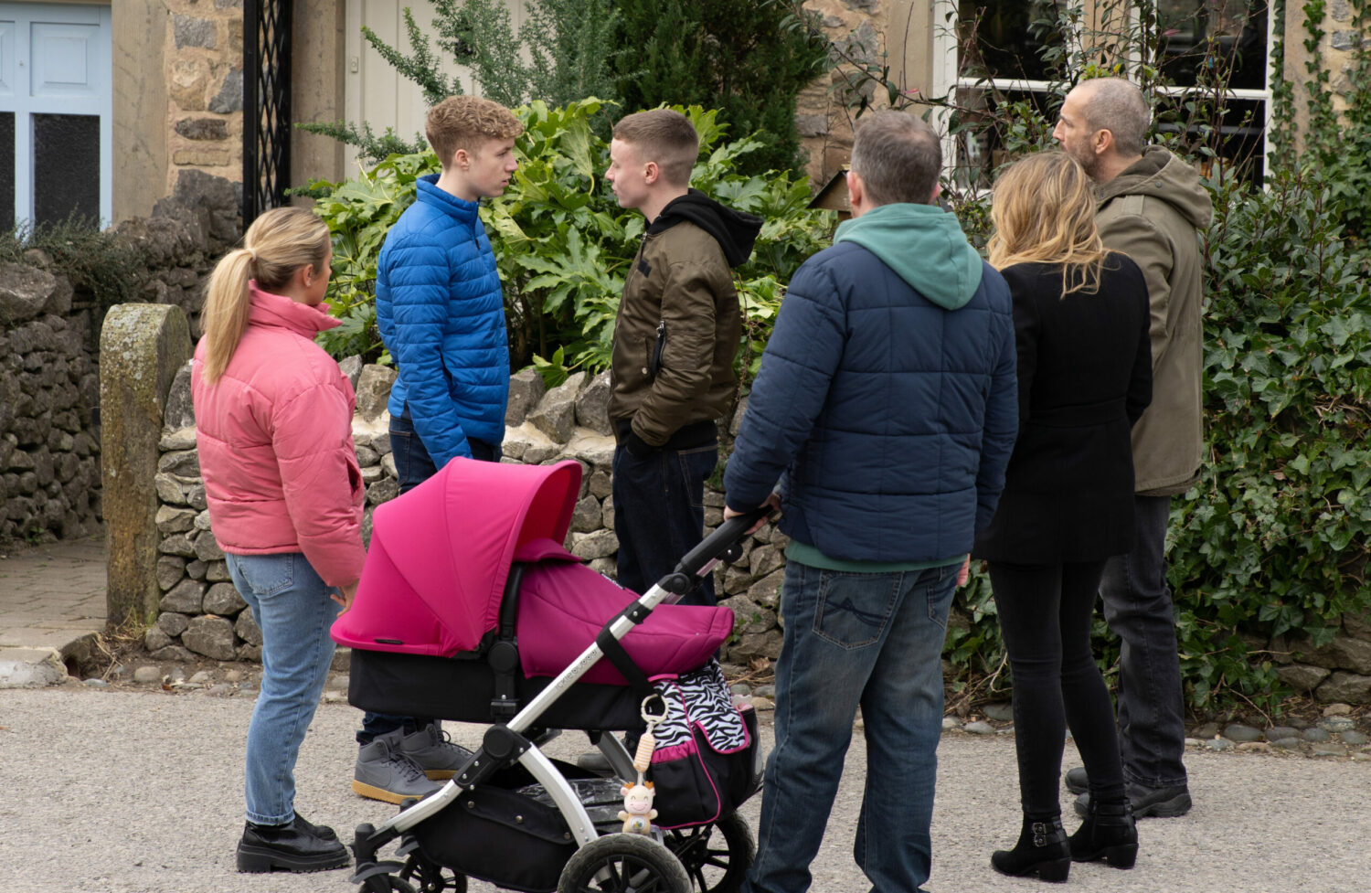 Emmerdale's Amelia, Noah, Samson, Dan, Sam and Charity are all gathered around Esther's pram outside whilst arguing