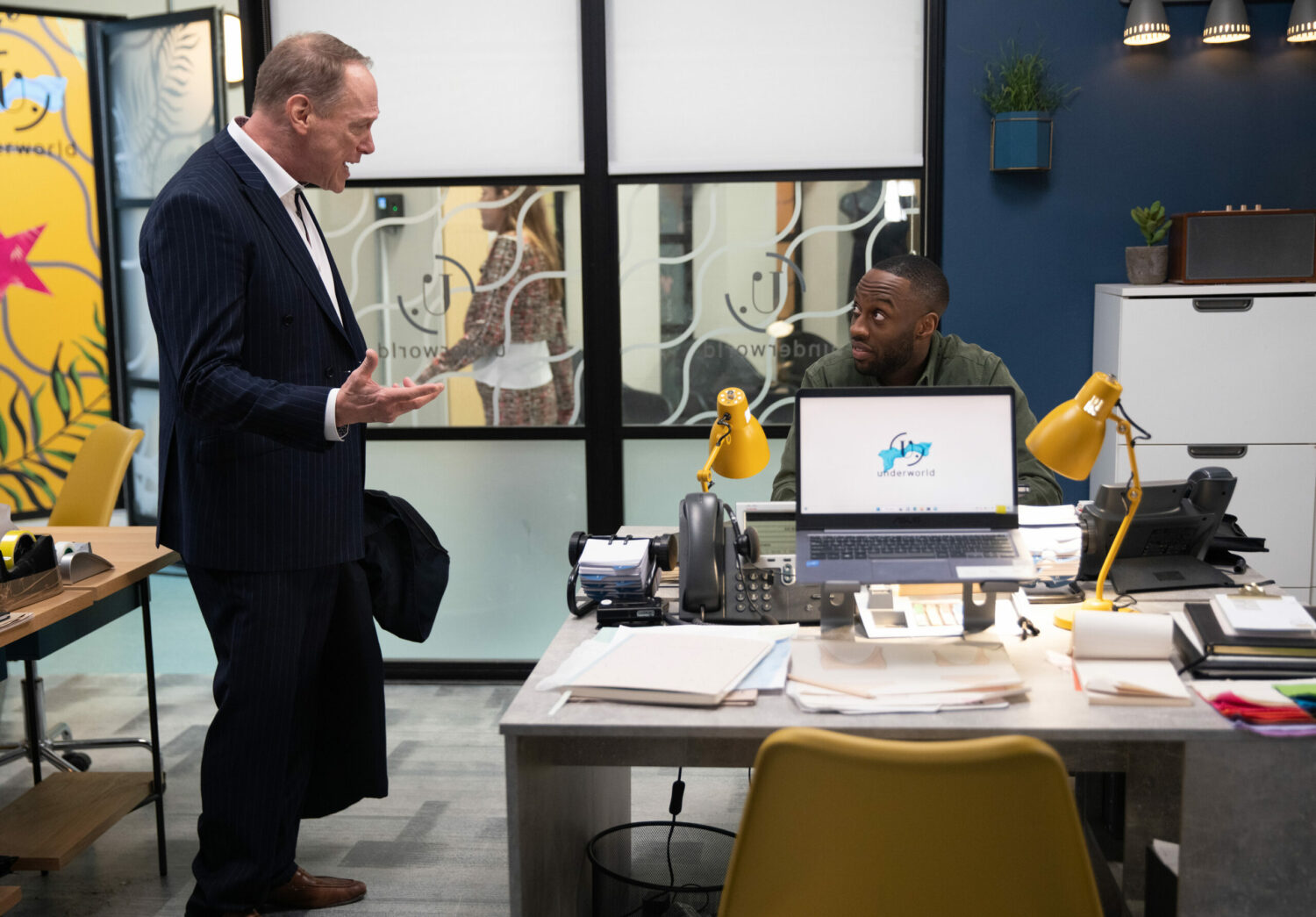 Stephen and Michael talk over the desk in the office on Underworld in Corrie
