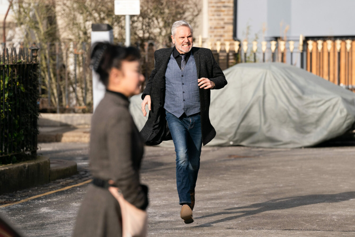 Rocky running through Albert Square while his ex walks over to see Kathy on EastEnders