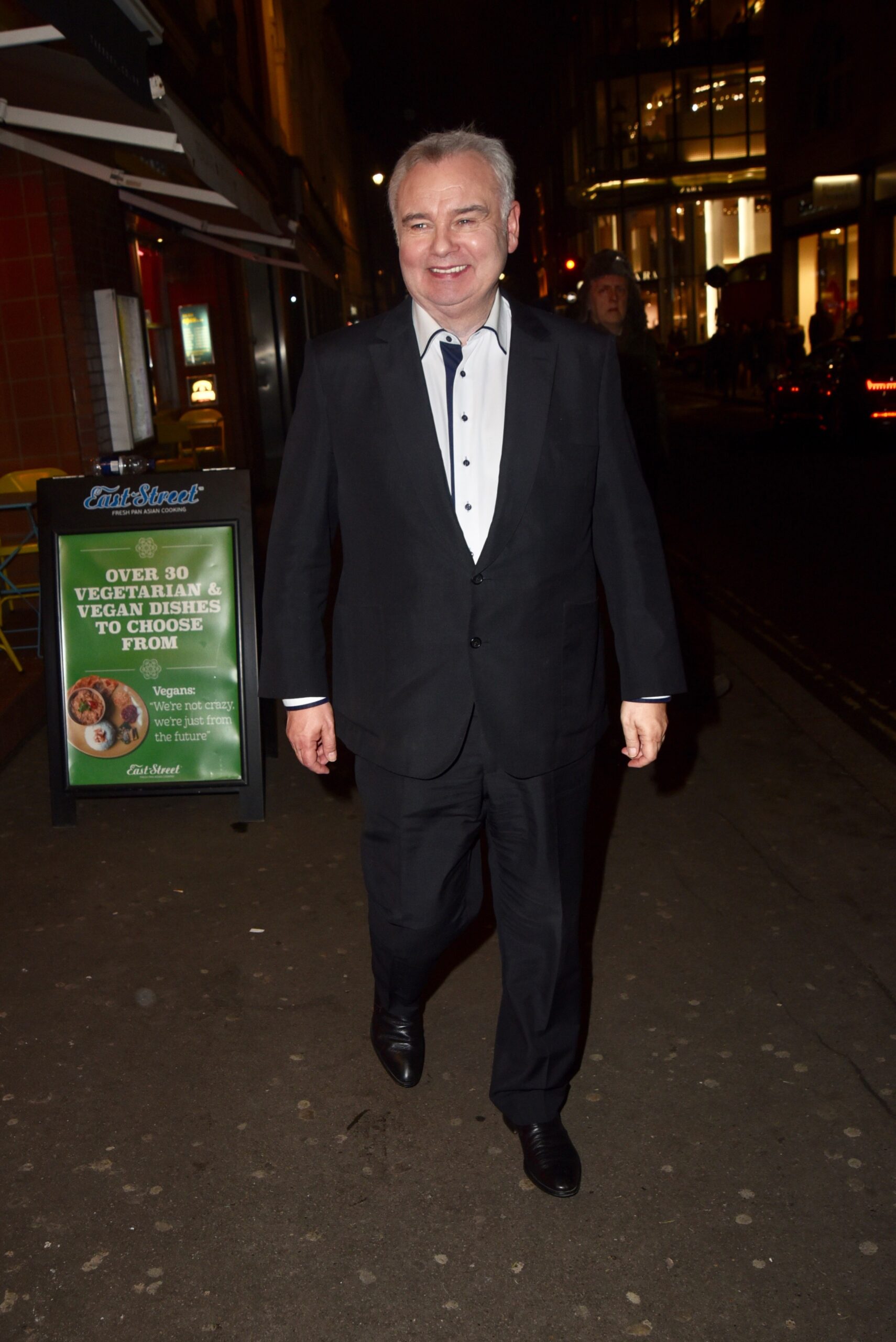 Eamonn Holmes wearing a suit and smiling