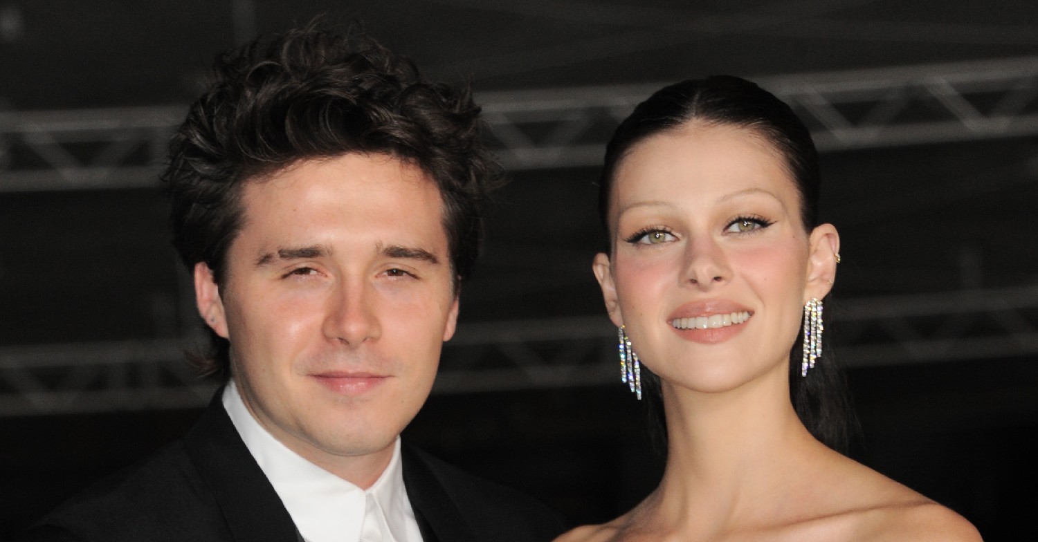 Brooklyn Beckham smiling with Nicola at an event 