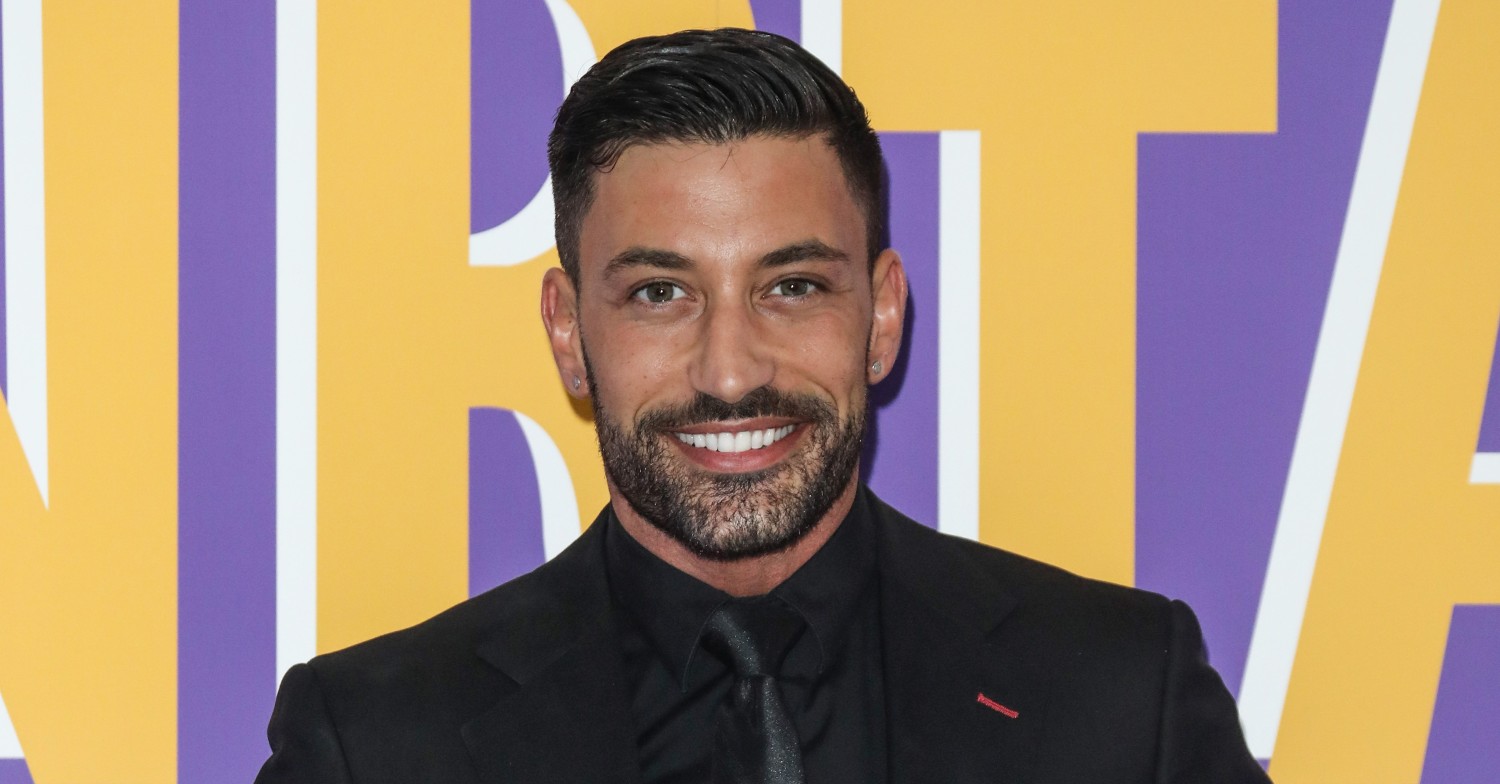 Giovanni Pernice smiling on a red carpet 