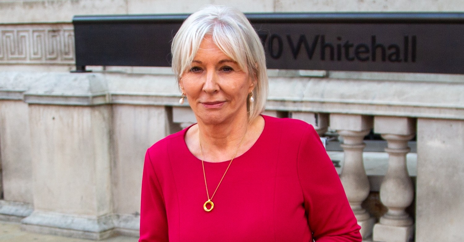 Nadine Dorries in red, smiling 