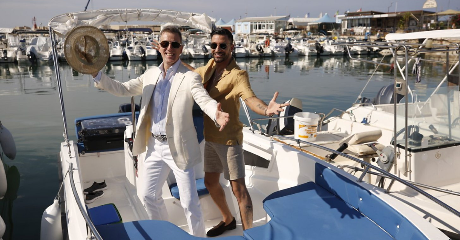 Anton and Giovanni pose on a yacht