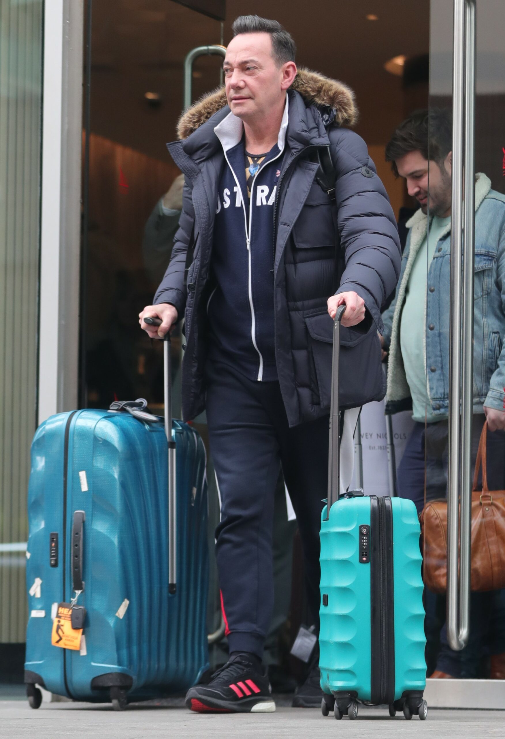 Craig Revel Horwood wheeling suitcases