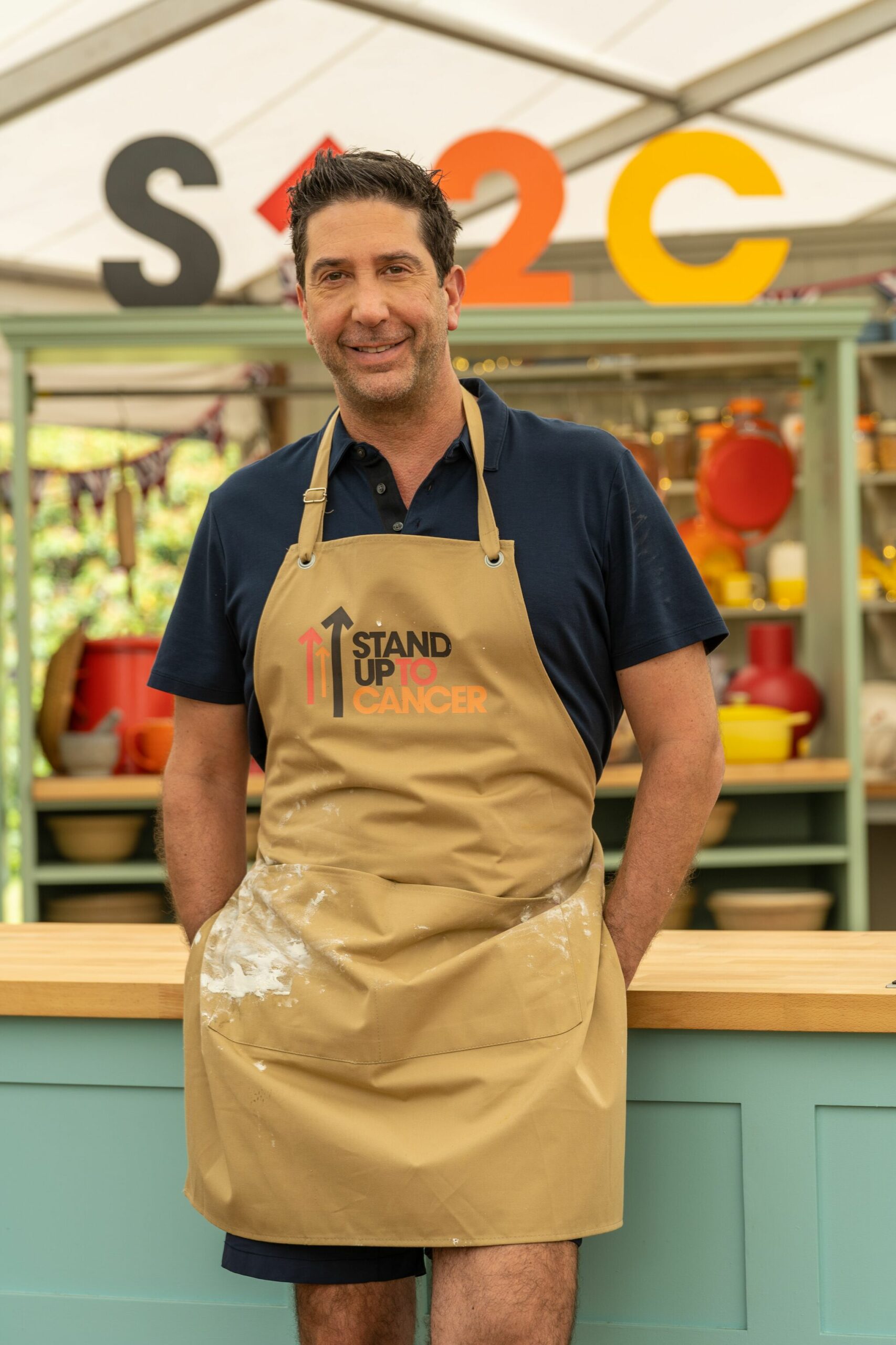 David Schwimmer wears Stand Up to Cancer apron on GBBO