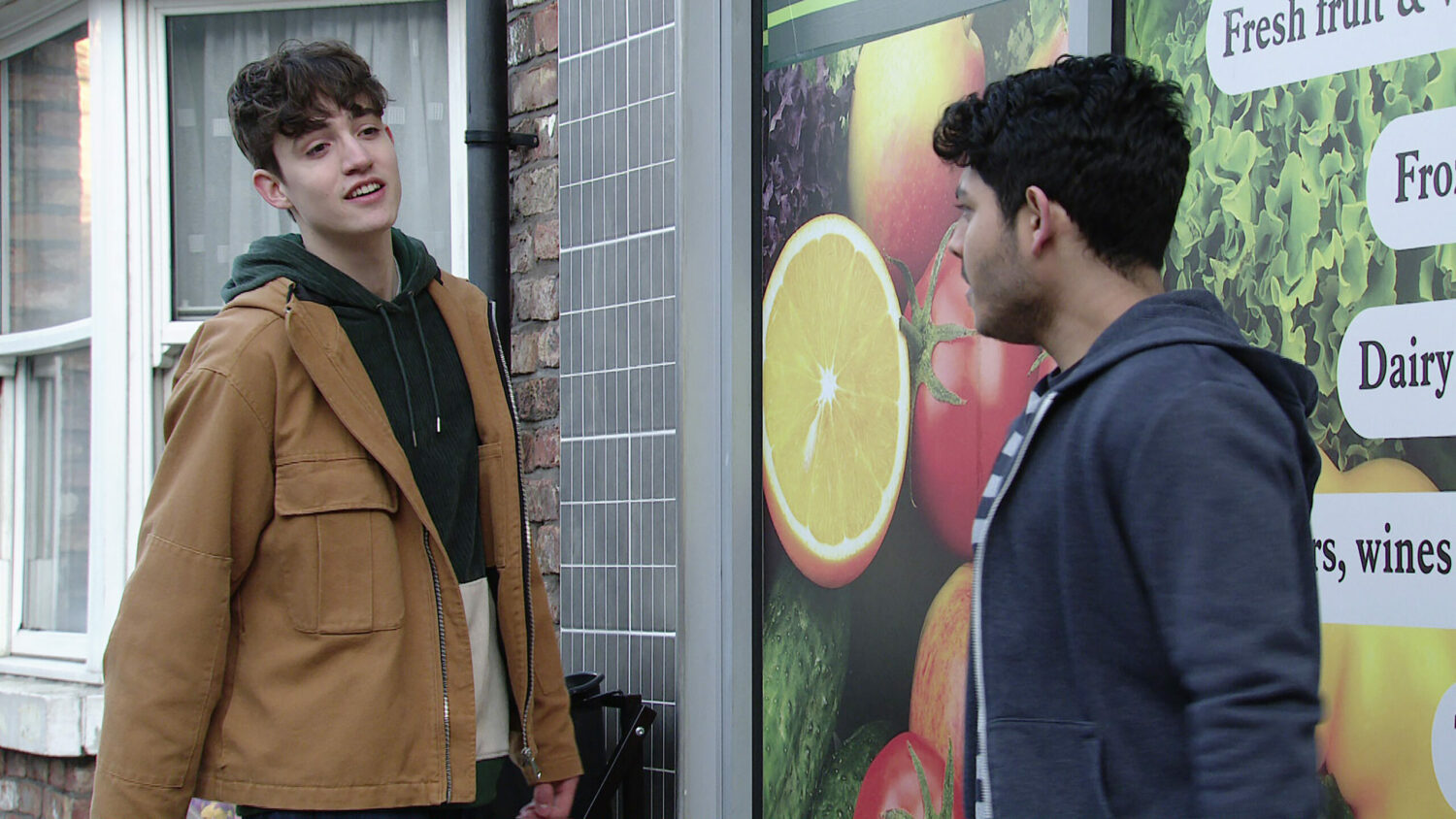 Aaron in Coronation Street spoilers smiles at Aadi outside the corner shop.