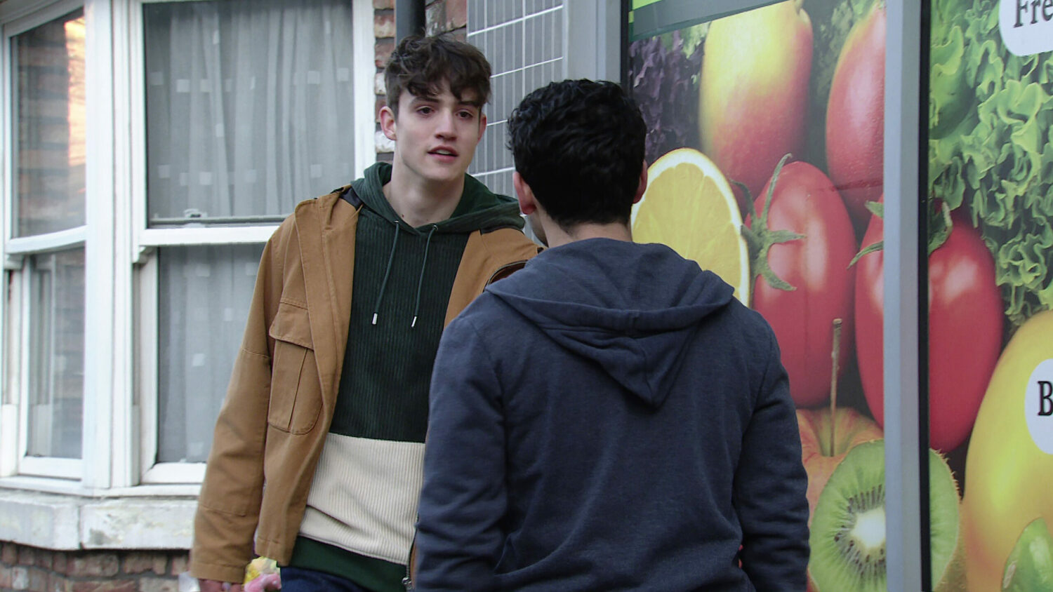 Aadi confronts Aaron outside the shop on Corrie