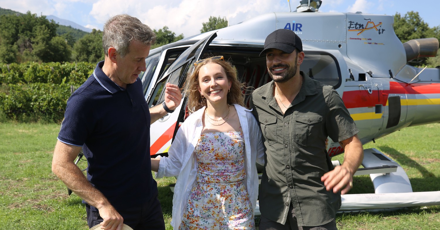 Anton, Giovanni and Rose standing in front of a helicopter