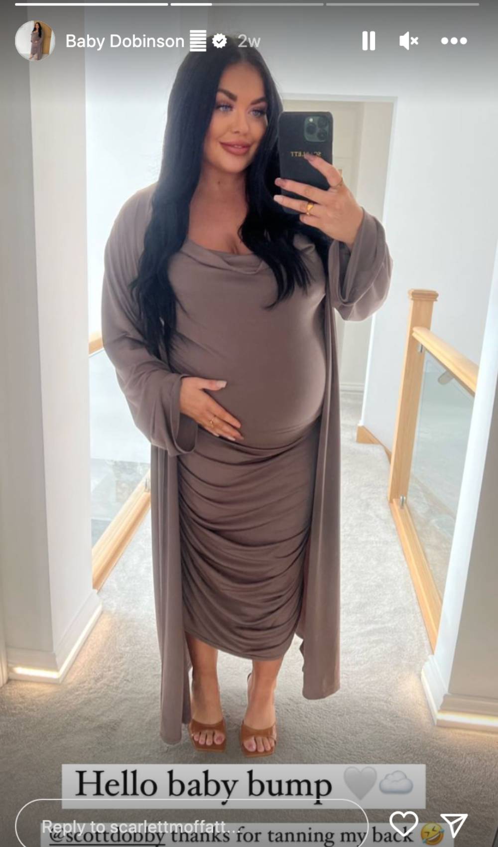 Scarlett Moffatt cradles her baby bump