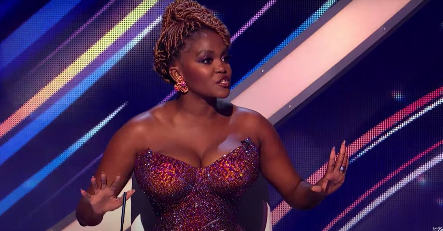 Oti Mabuse raises her hands on DOI