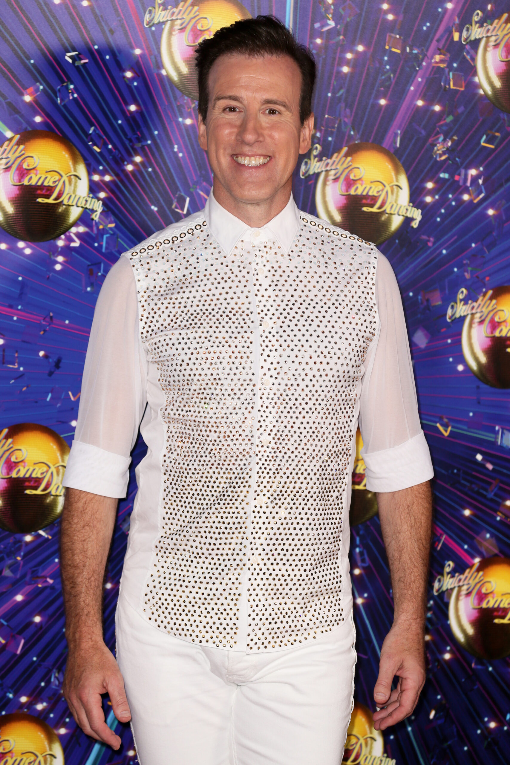 Anton Du Beke posing in a white outfit on Strictly 