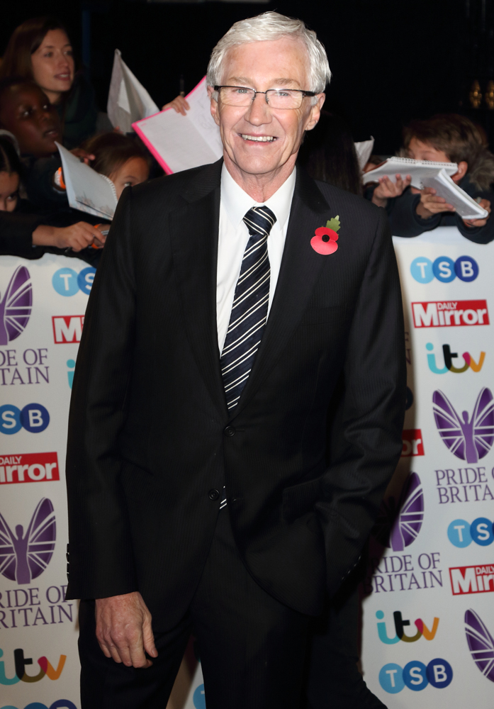 Paul O'Grady smiles on the red carpet
