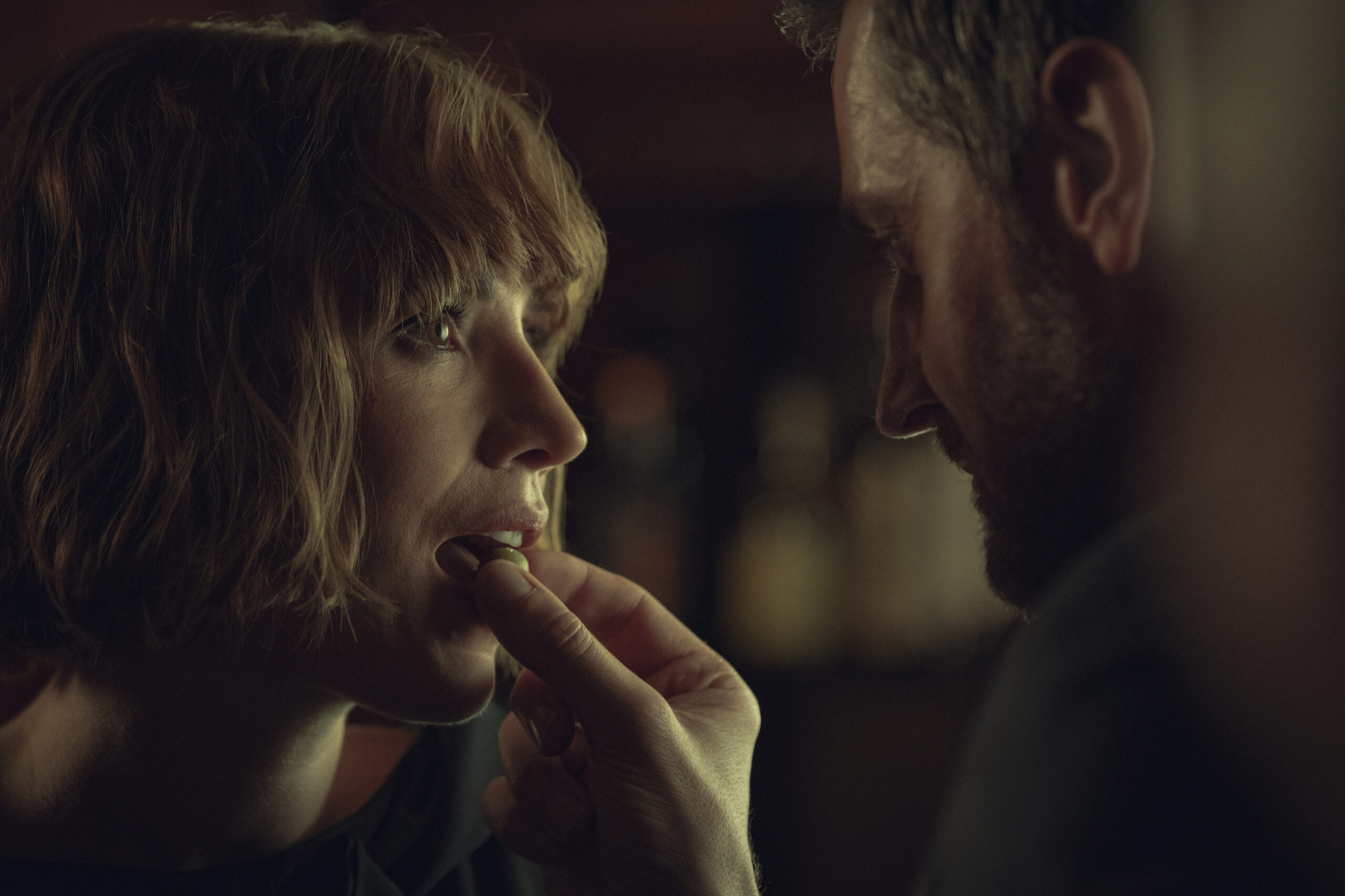 Richard Armitage feeds something into Charlie Murphy's mouth in Obsession