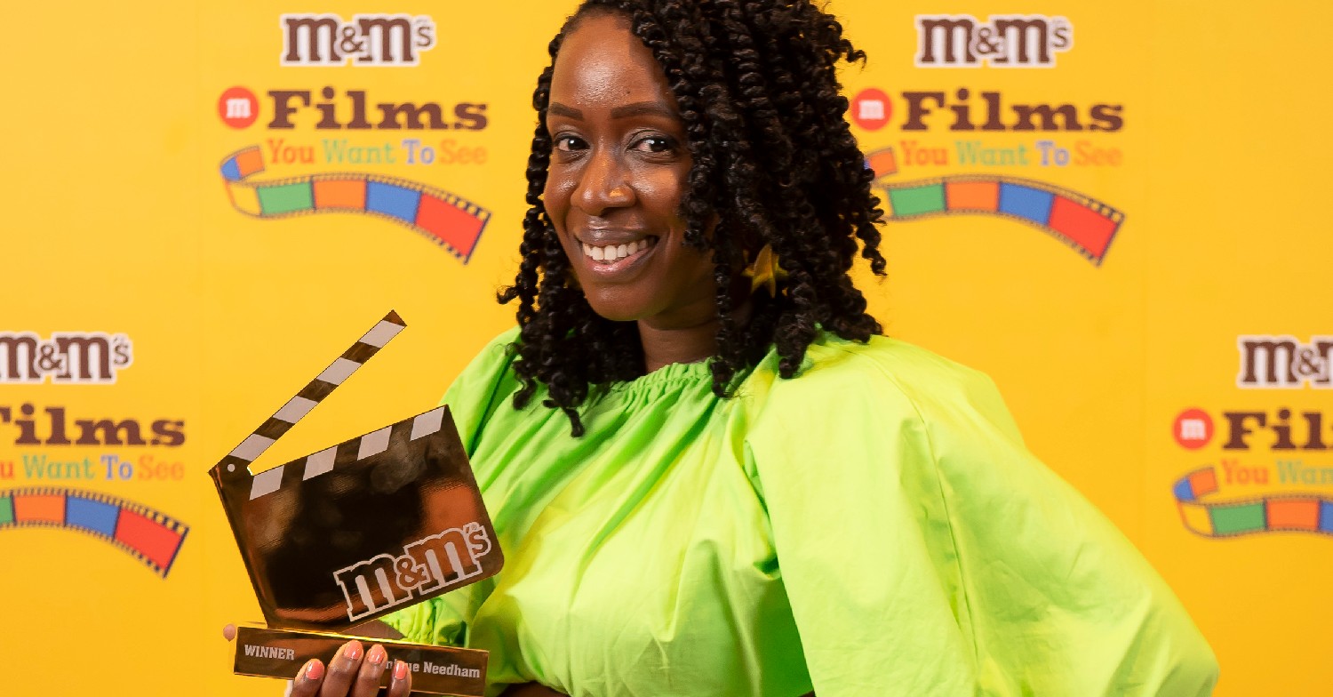 Monique Needham wearing a green dress at the M&M's #FilmsYouWantToSee campaign