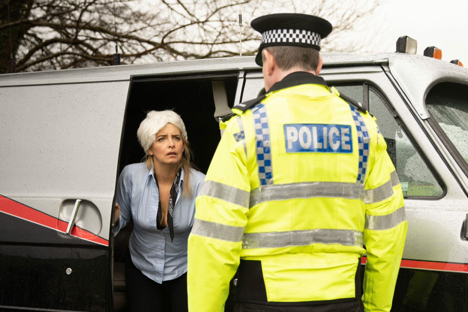 Charity looks horrified as she's confronted by PC Swirling on Emmerdale