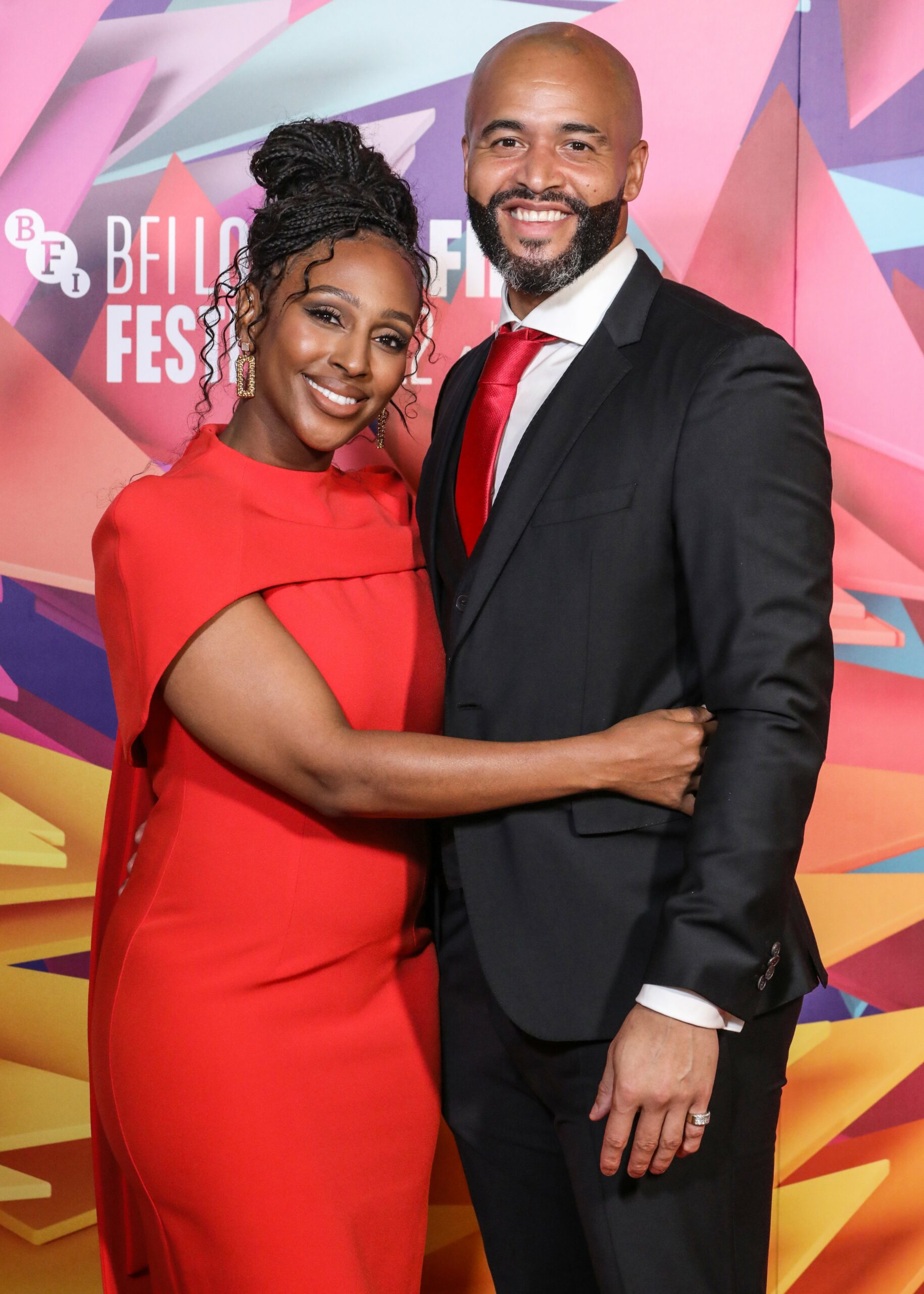 Alexandra Burke hugging partner Darren at event