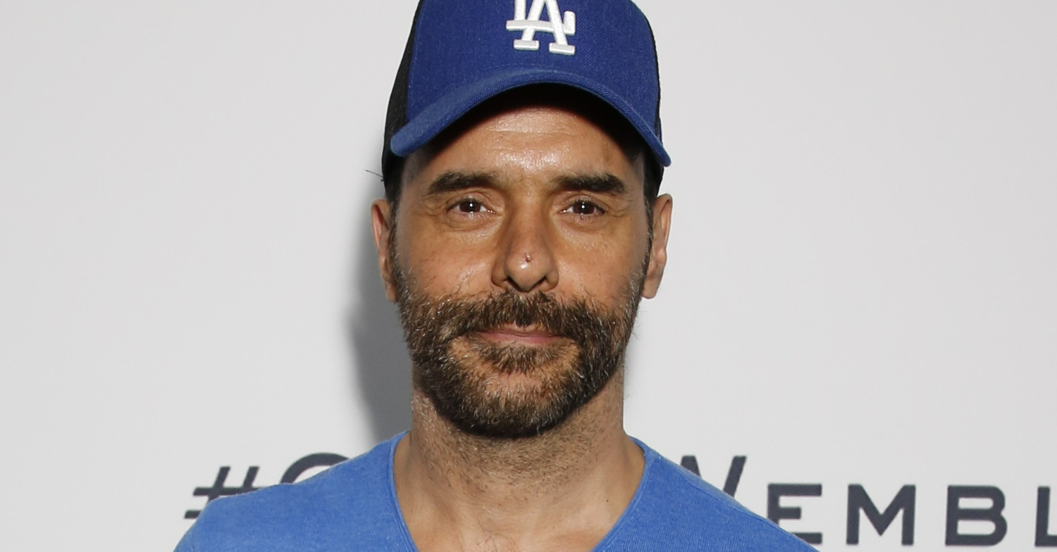 EastEnders' Michael Greco wearing a blue baseball cap