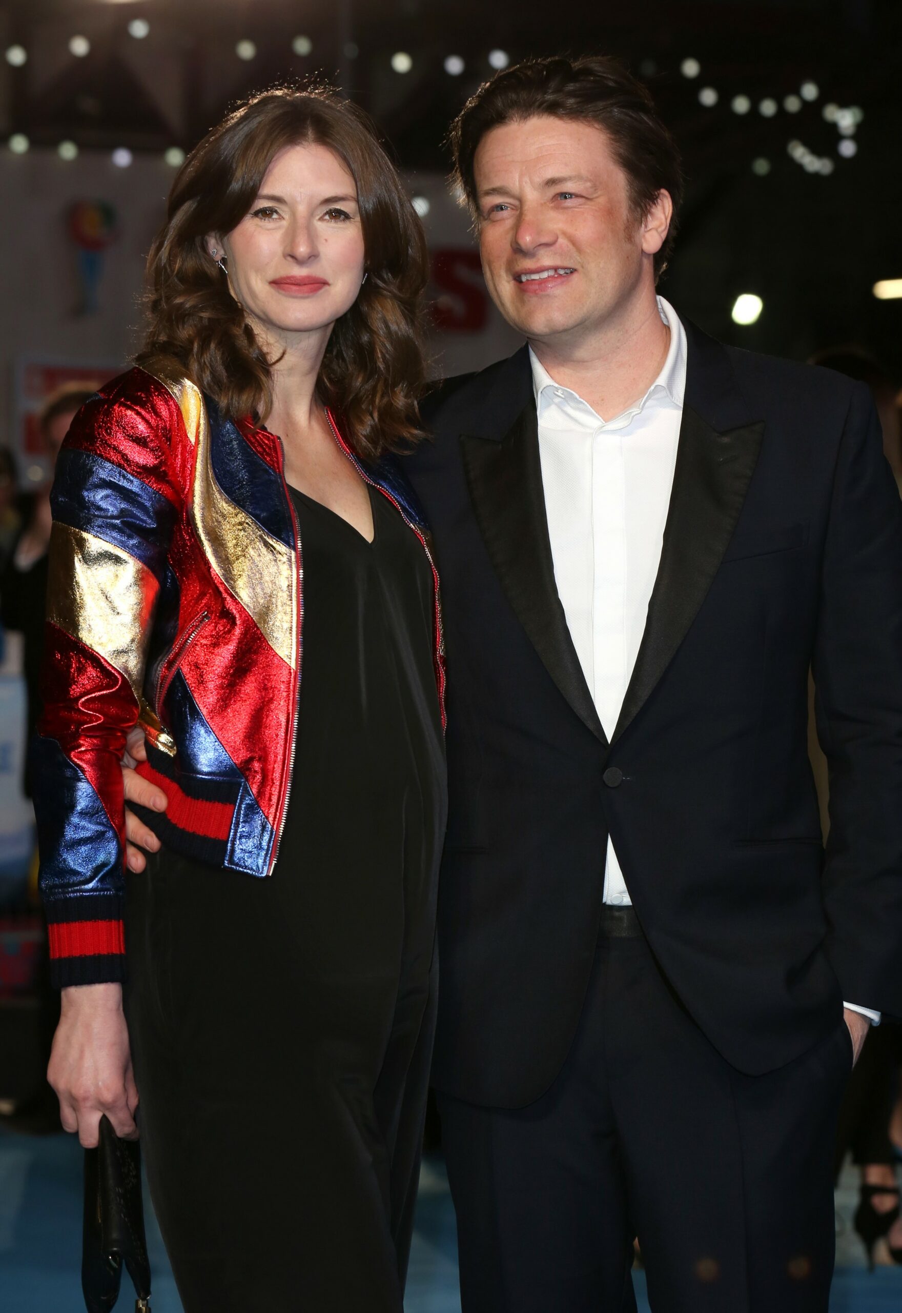 Jamie Oliver and wife Jools smiling at event