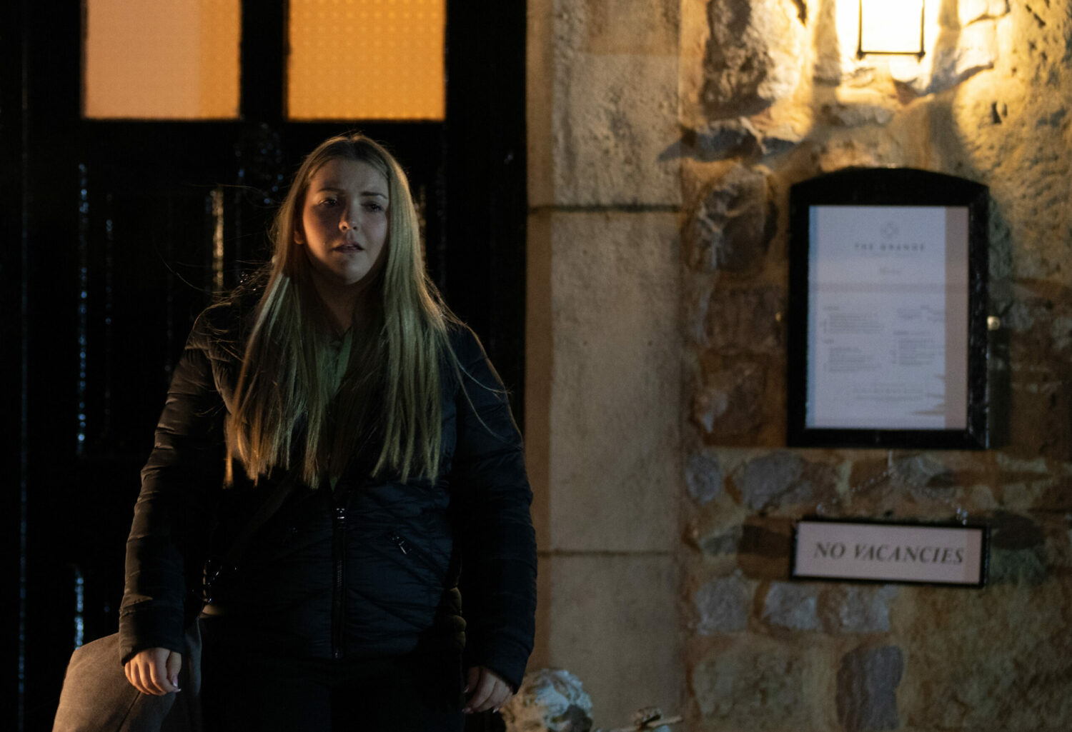 Cathy looking sad as she stands outside of the B&B on Emmerdale