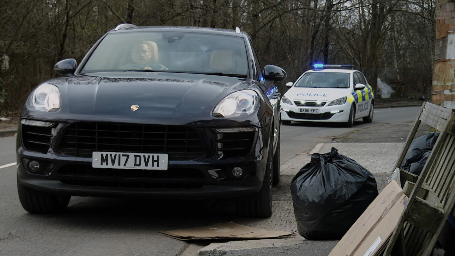 Paul driving a car on Coronation Street