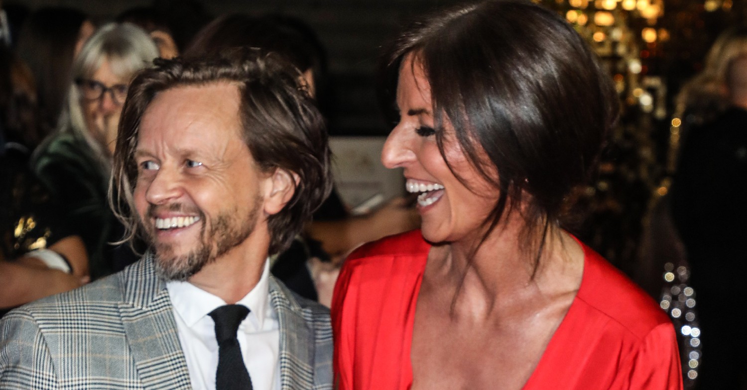 Davina McCall and her boyfriend Michael Douglas posing on a red carpet 