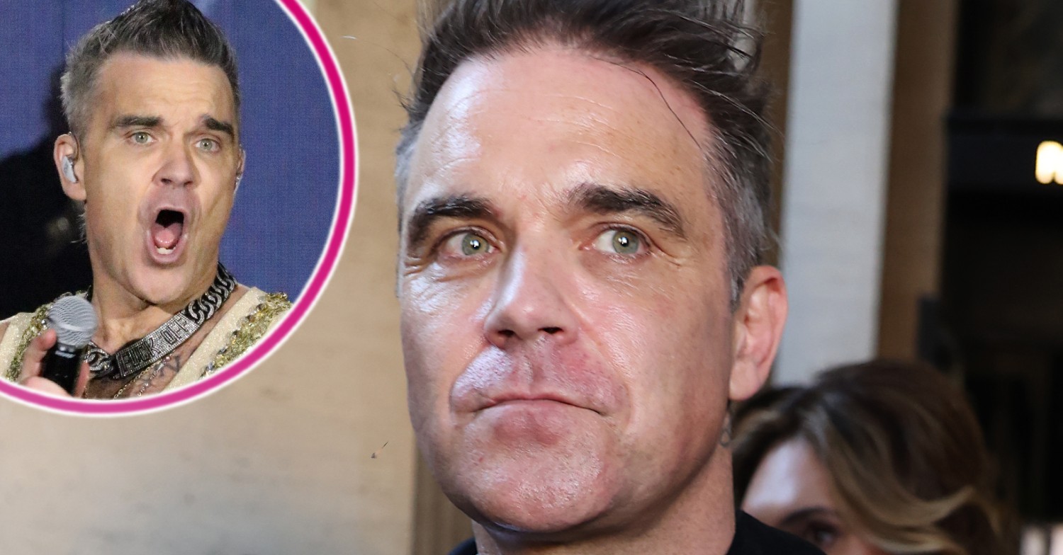 Robbie Williams smiling during a concert