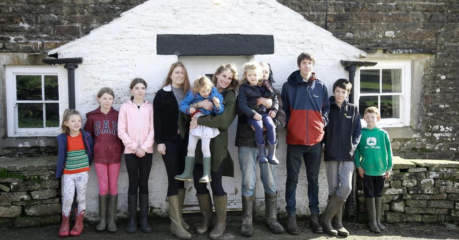 Amanda poses with their 9 children on Our Yorkshire Farm