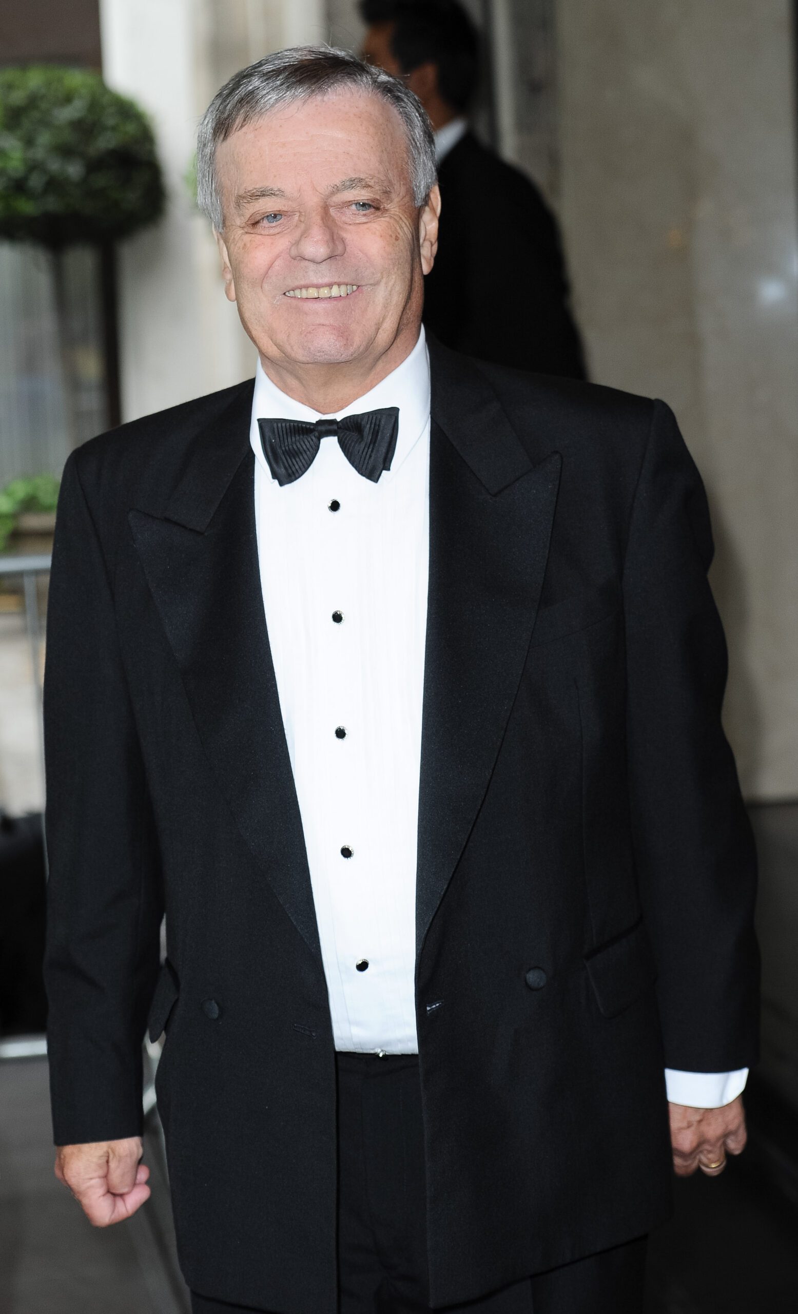 Tony Blackburn smiles in suit and bow tie