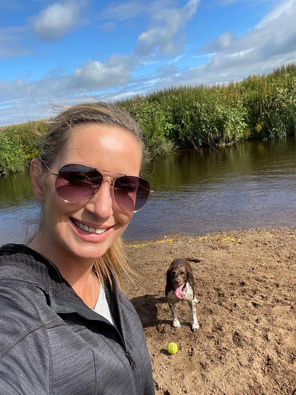 Nicola Bulley smiles with her dog on the river bank