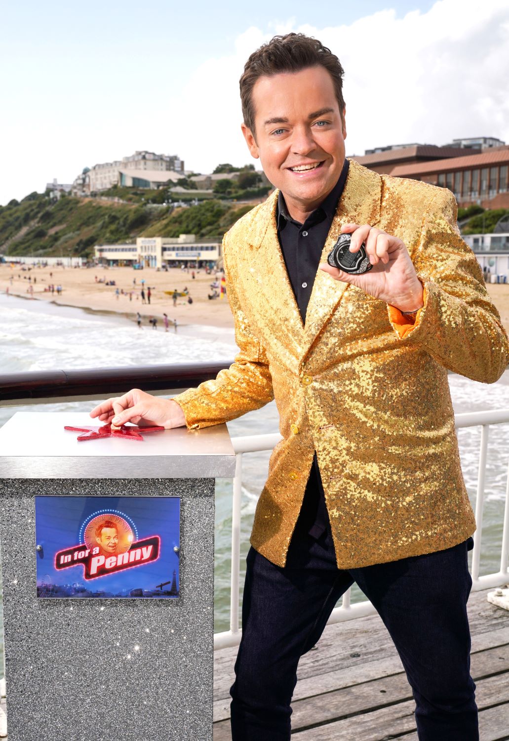 Stephen Mulhern grins as he poses for In For A Penny promo shot