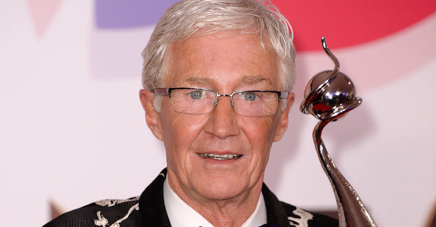 Paul O'Grady smiling holding an award 