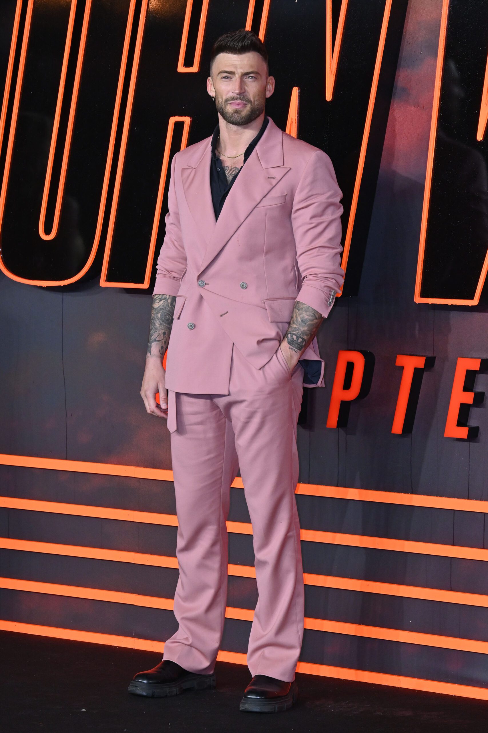 London Marathon runner Jake Quickened wearing a pink suit at the John Wick premiere 