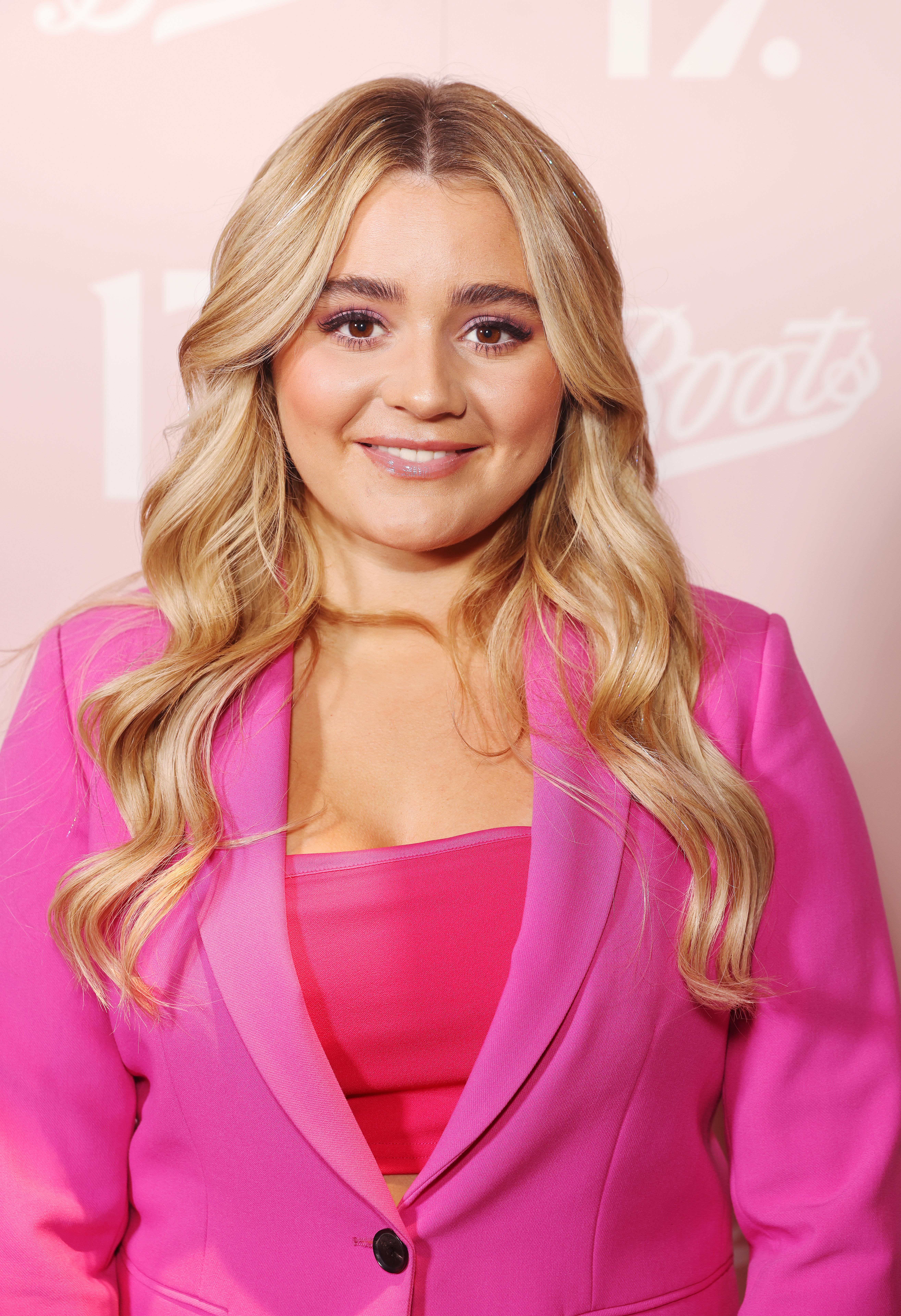 Tilly Ramsay posing in a pink suit