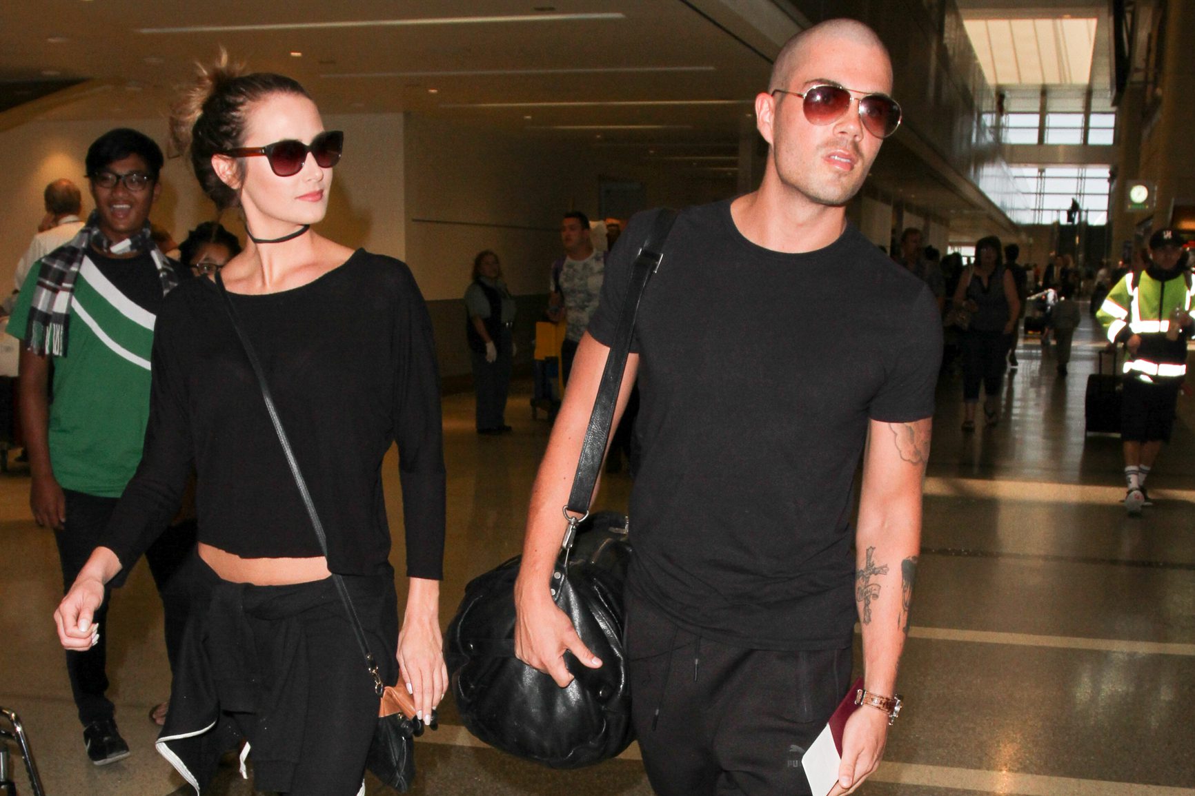 Max George and Carrie Baker wearing sunglasses at the airport