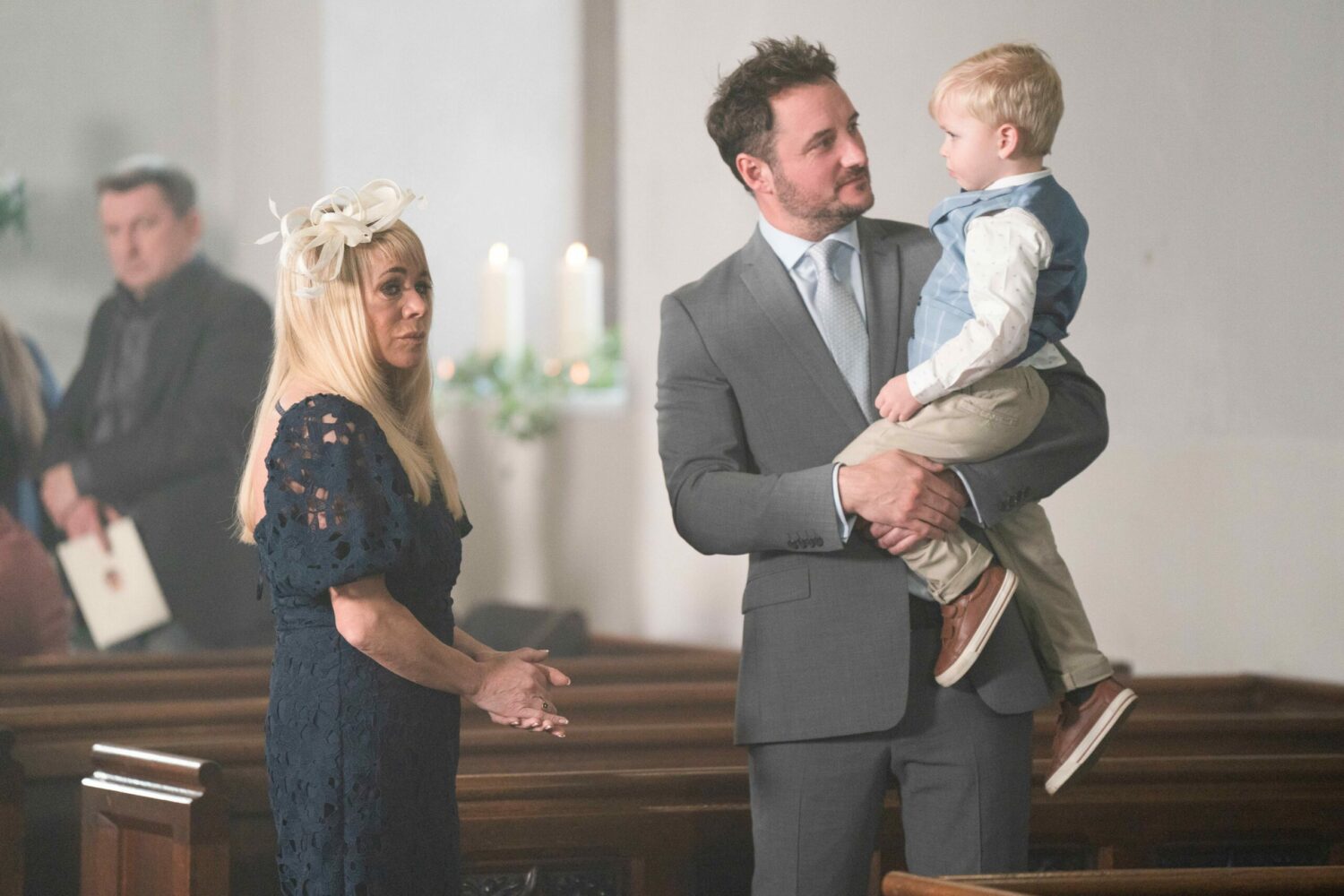 Sharon Watts looks anxious in the church as Martin Fowler smiles at Albie