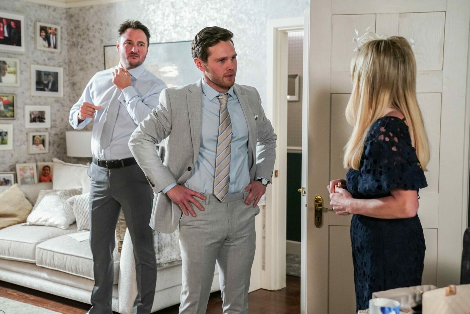 Martin watches on in EastEnders as Keanu, with his hands on his hips, talks to Sharon looking frustrated