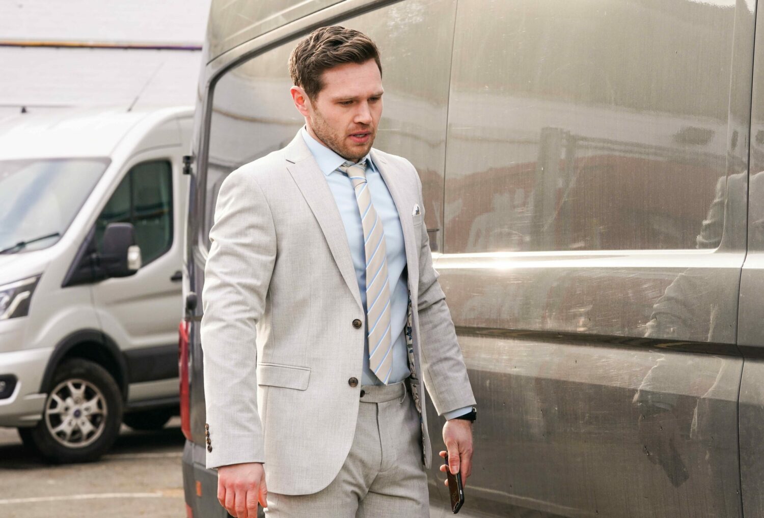 Keanu in EastEnders looks worried as he spies the flat tyre